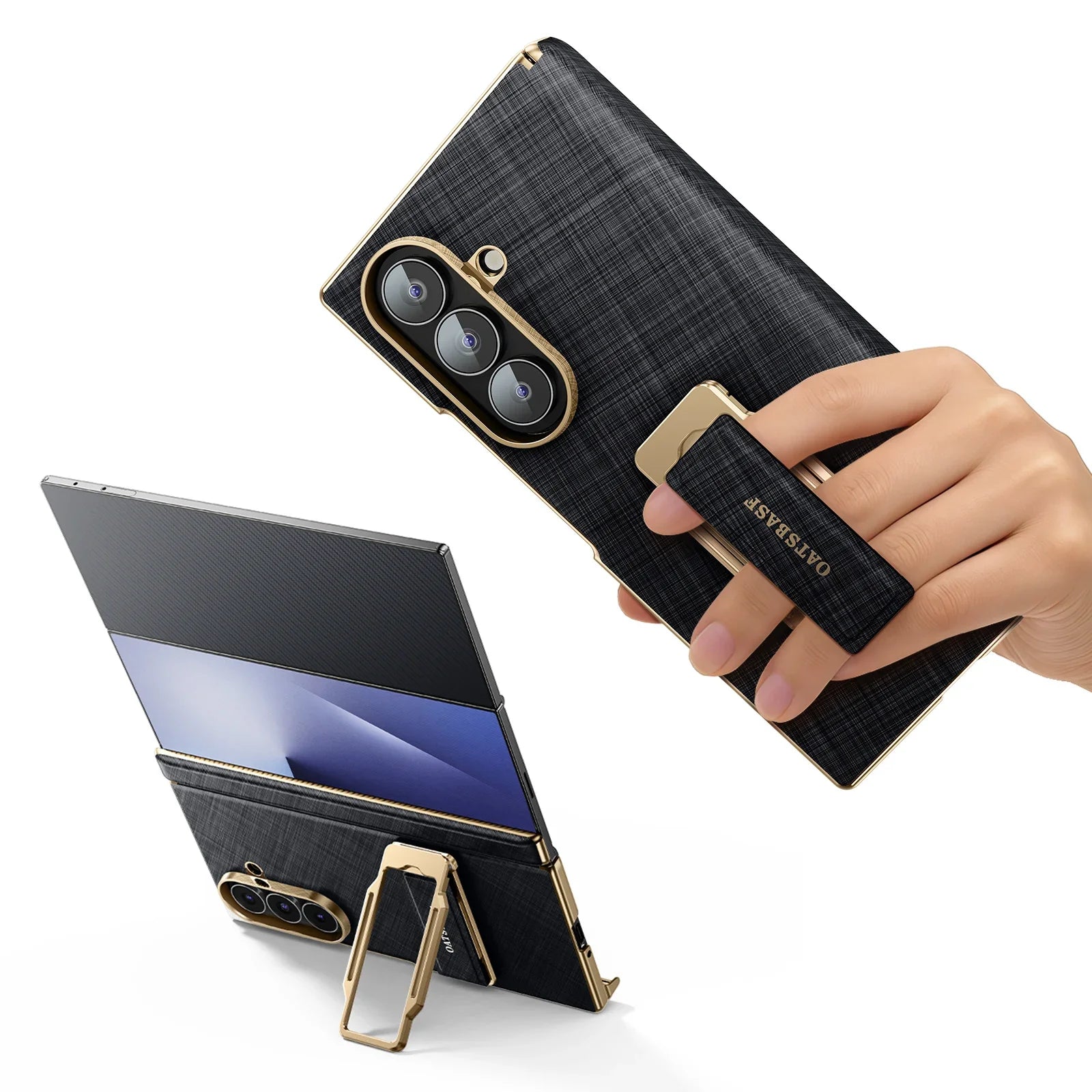 Smartphone with a black and gold case held by a hand, with a stand attached to the back.